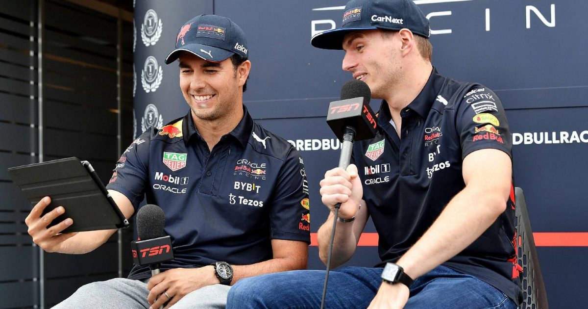 Max Verstappen and Sergio Perez looking at an iPad. Montreal June 2022.