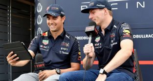 Max Verstappen and Sergio Perez looking at an iPad. Montreal June 2022.