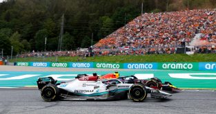 George Russell, Mercedes, alongside Sergio Perez's Red Bull. Red Bull Ring July 2022.