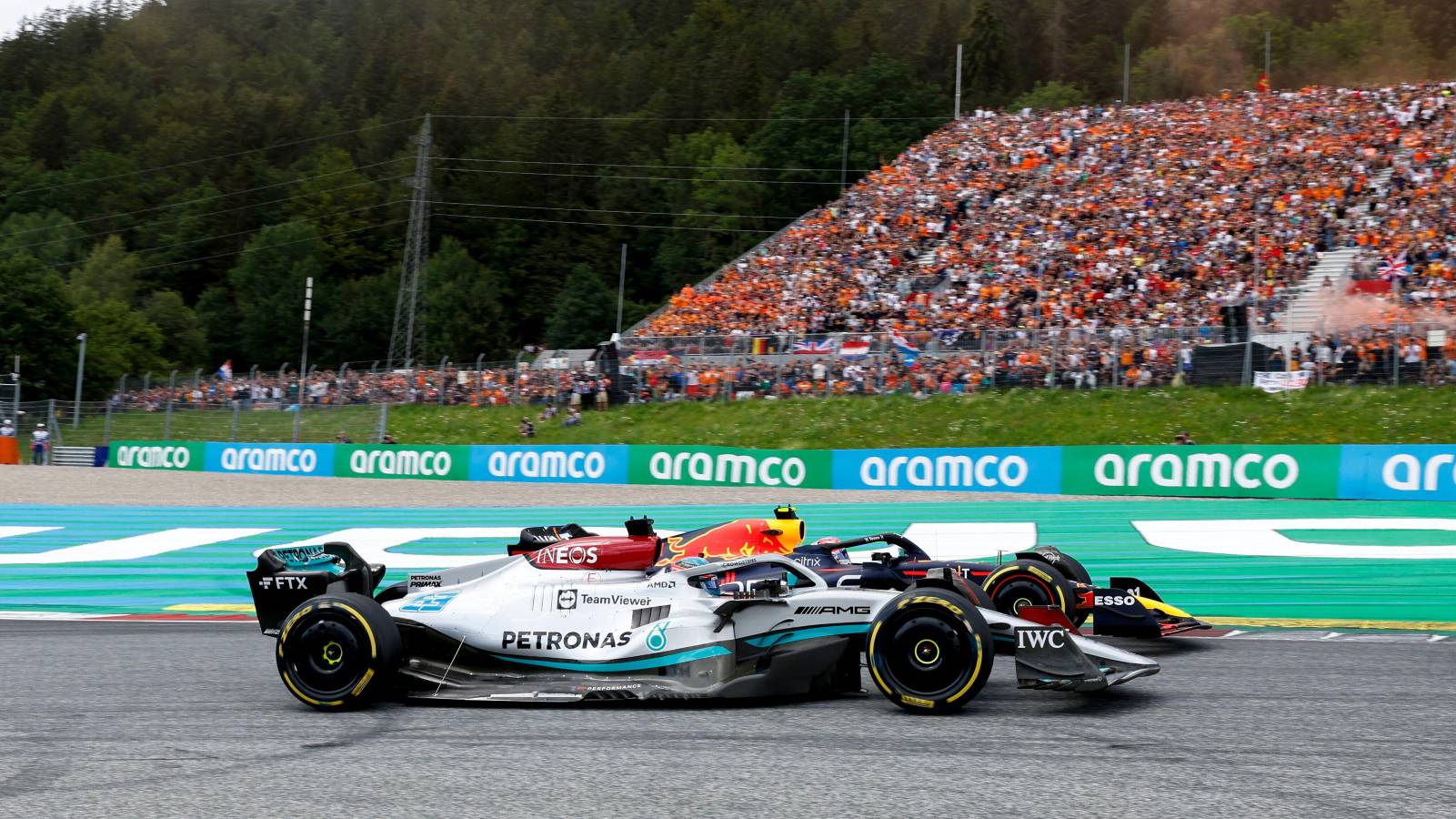 George Russell, Mercedes, alongside Sergio Perez's Red Bull. Red Bull Ring July 2022.
