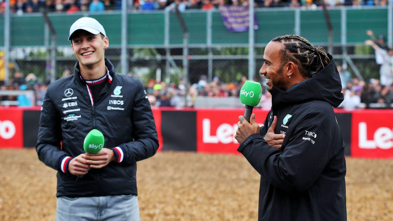 Lewis Hamilton and George Russell talking into microphones. Silverstone July 2022.