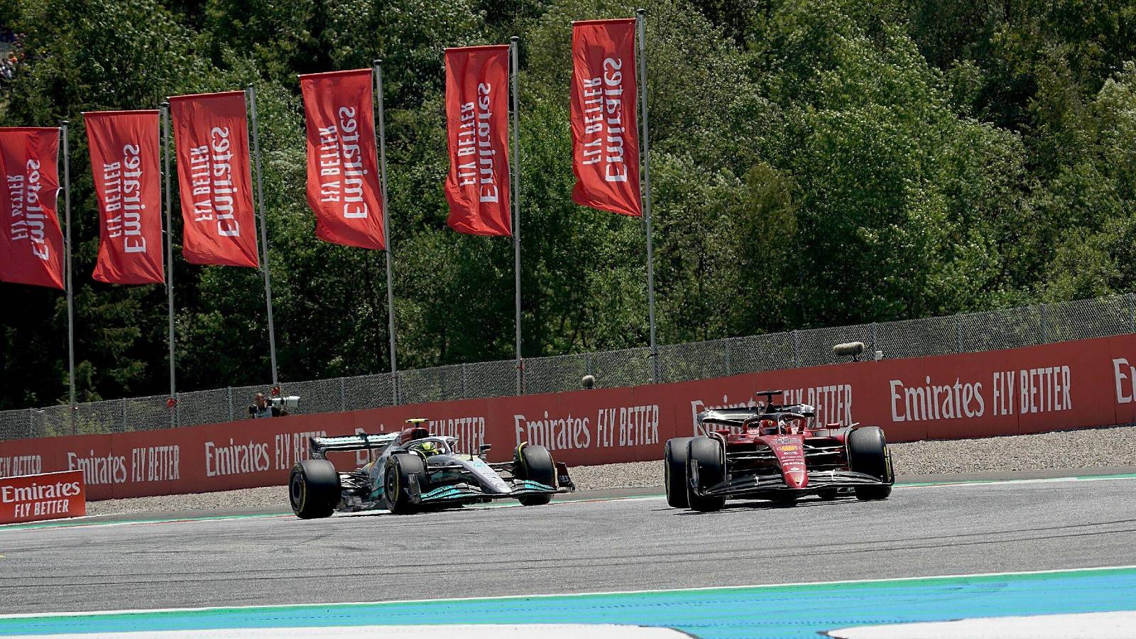 Lewis Hamilton's Mercedes follows Charles Leclerc's Ferrari. Red Bull Ring July 2022.
