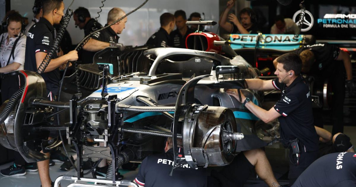 Mercedes mechanics work on George Russell's car. Red Bull Ring July 2022.