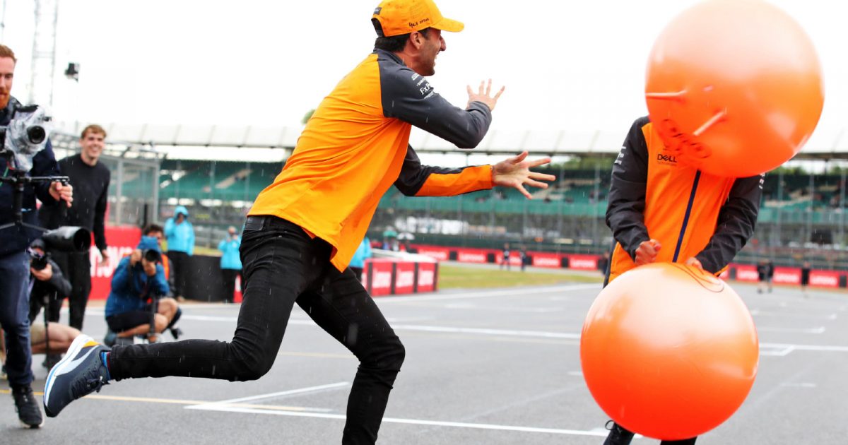 McLaren's Daniel Ricciardo bounces a space hopper off Lando Norris' face at the British Grand Prix. Silverstone, July 2022.