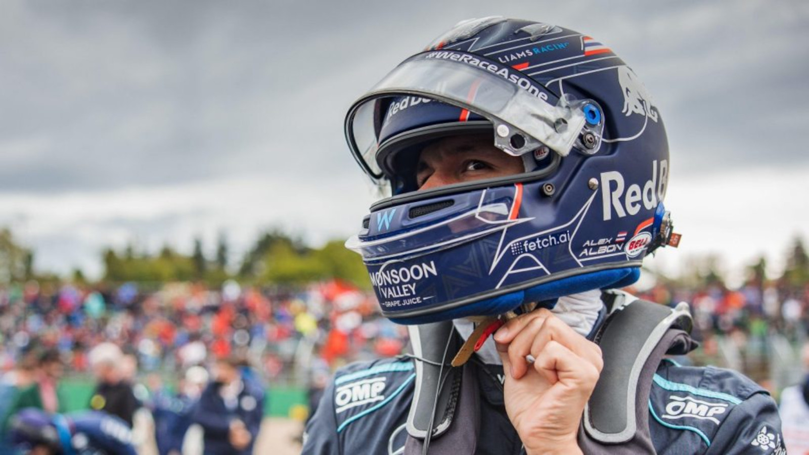Alex Albon doing up his helmet straps. Imola April 2022