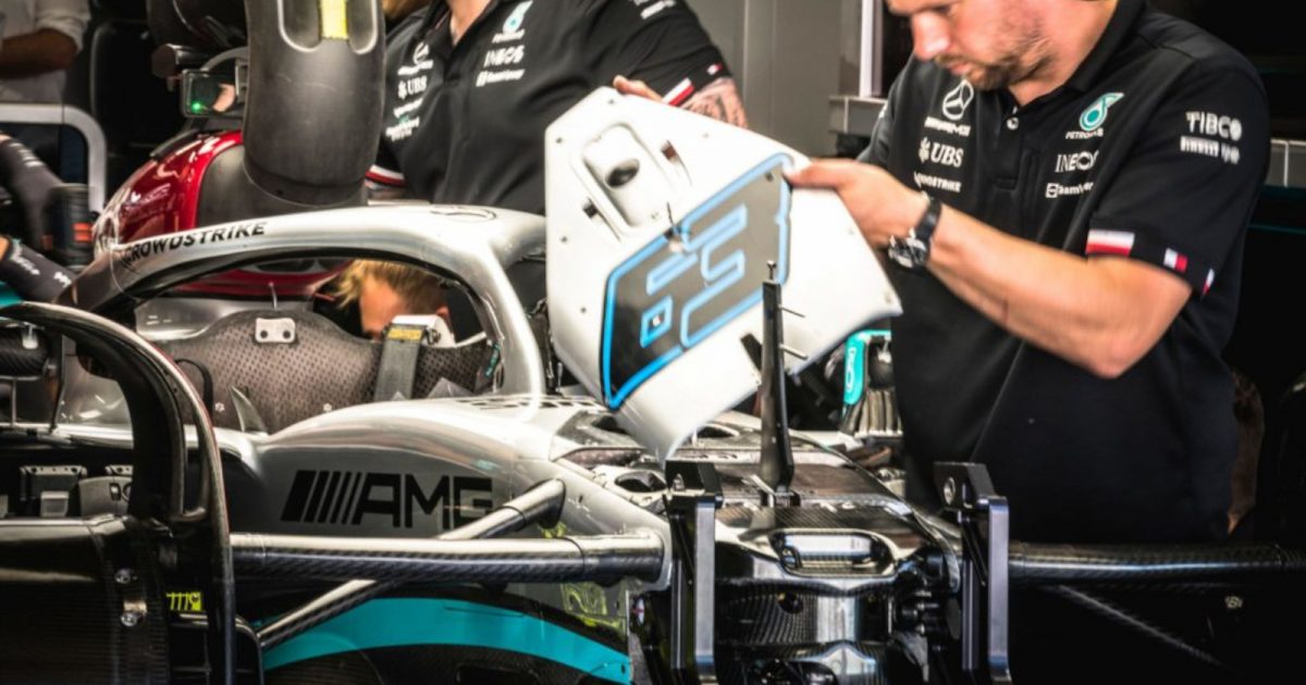 Mercedes mechanics working on George Russell's No63 W13 in the garage. Spain May 2022