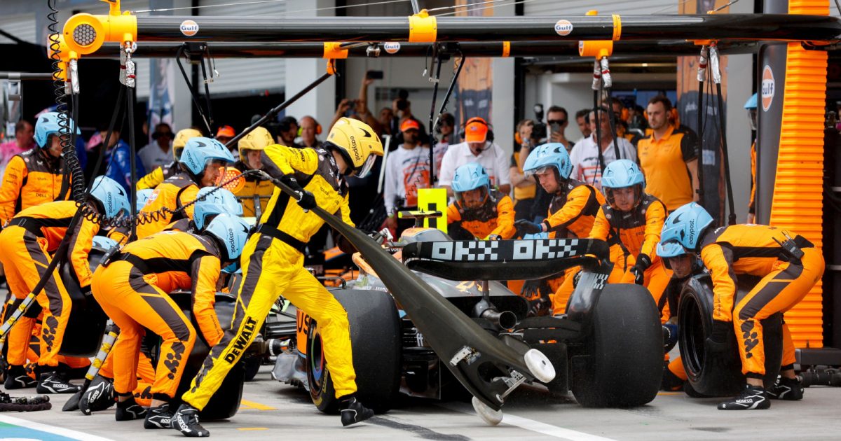 Lando Norris surrounded by mechanics in a pit stop. Miami May 2022