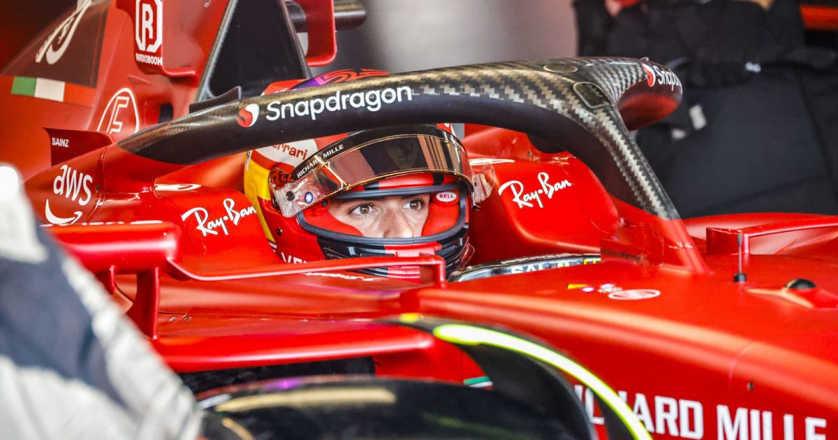 Carlos Sainz sitting in his car, visor up. France July 2022