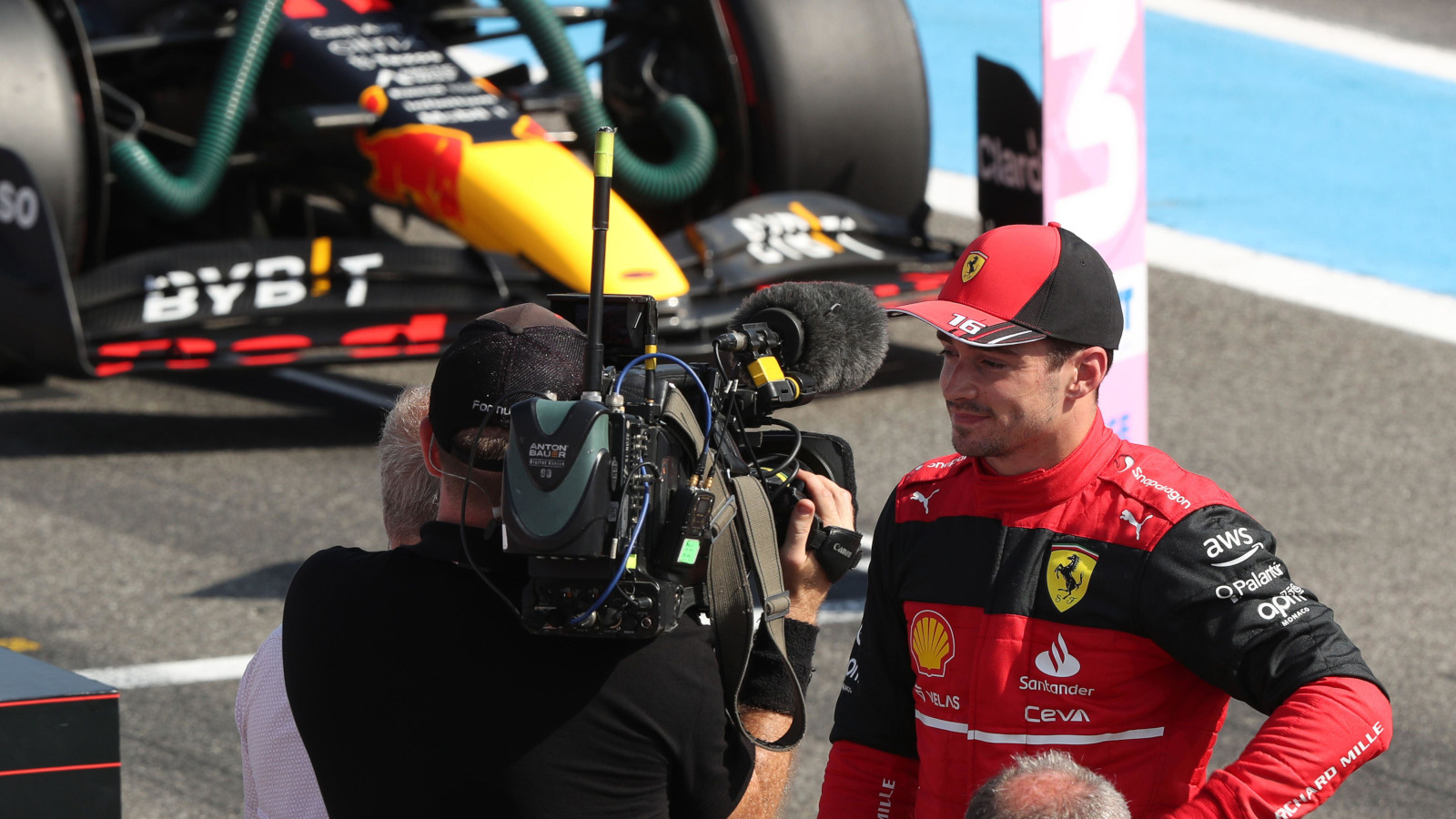 Charles Leclerc does a post qualifying interview, Red Bull in the background. France July 2022