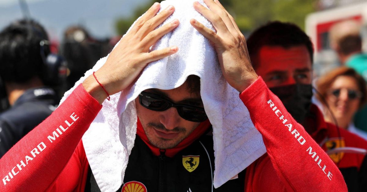 Charles Leclerc, Ferrari, holds a towel on his head. France, July 2022.