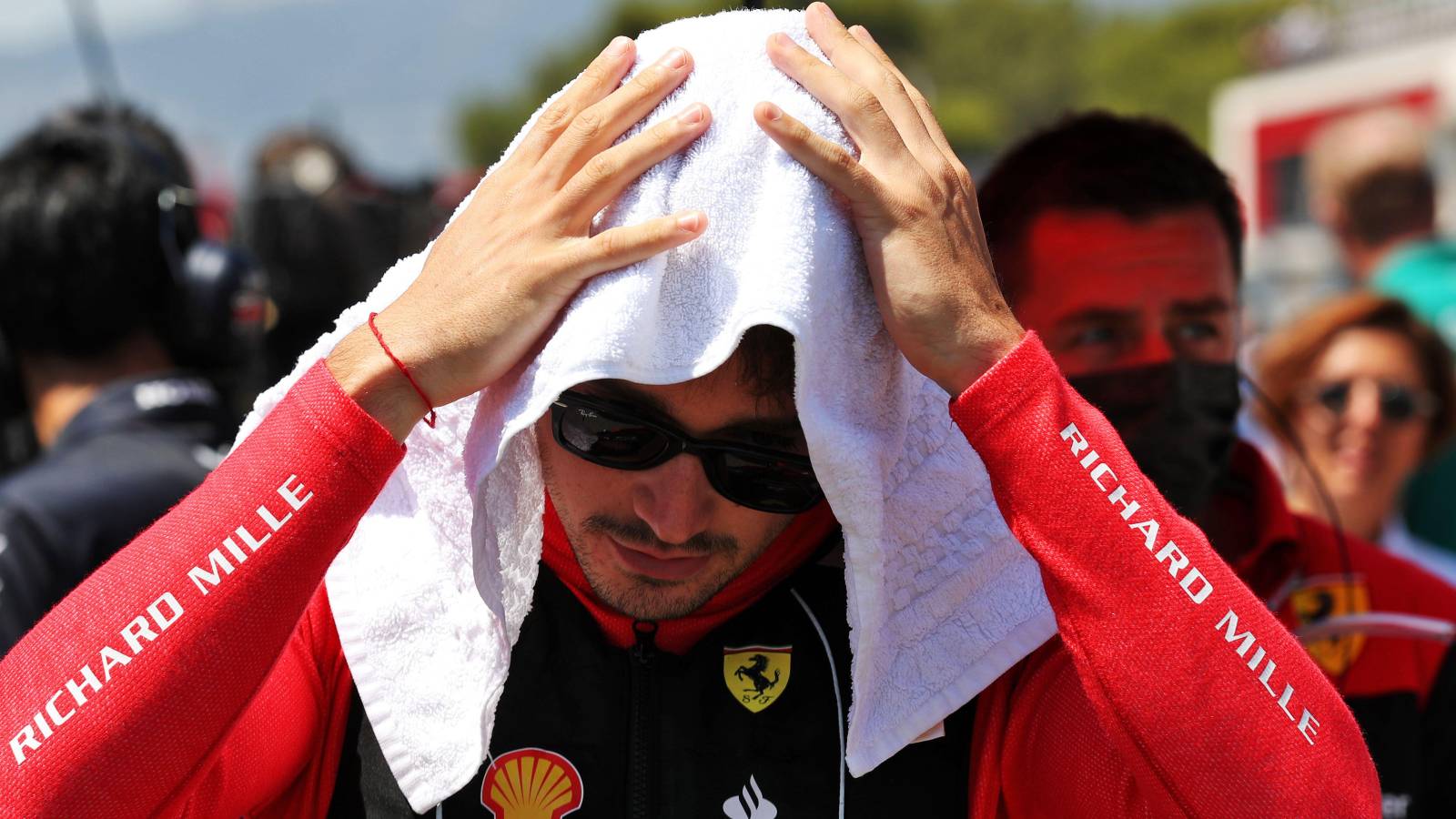 Charles Leclerc, Ferrari, holds a towel on his head. France, July 2022.