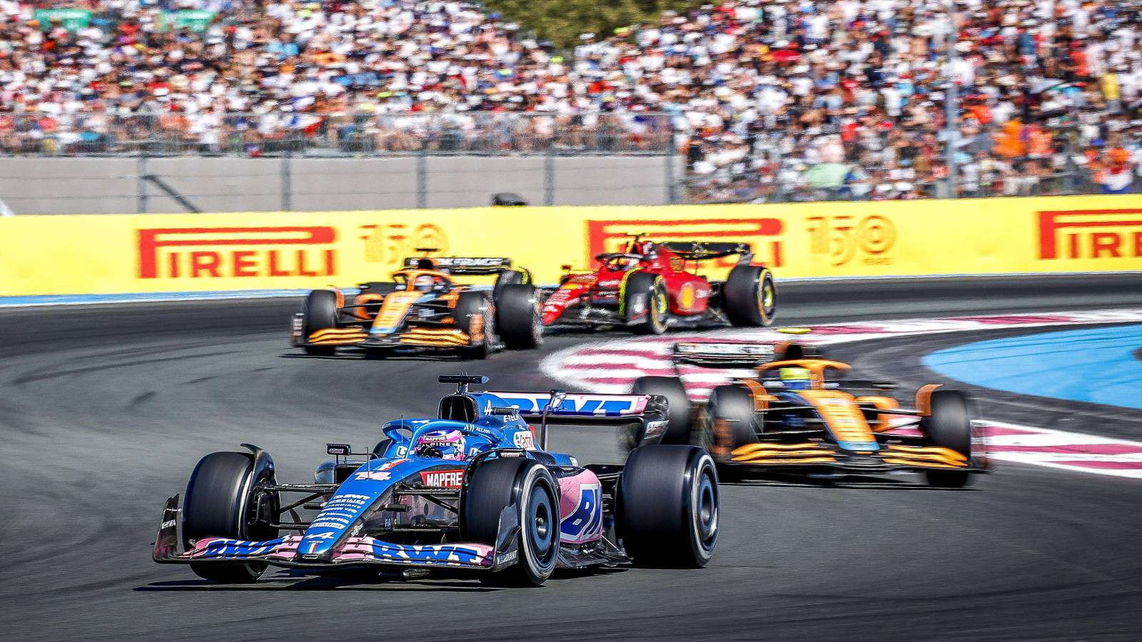 Fernando Alonso's Alpine leads both McLarens and Carlos Sainz's Ferrari. Paul Ricard July 2022.