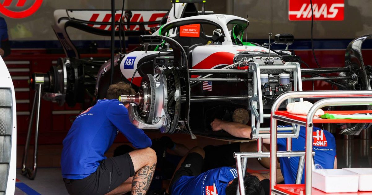 Haas mechanics working in the garage. Red Bull Ring July 2022.