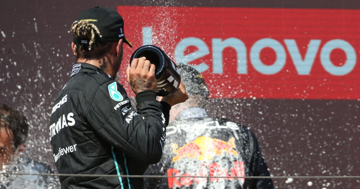 Lewis Hamilton sprays Max Verstappen with champagne on the podium. France July 2022