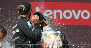 Lewis Hamilton sprays Max Verstappen with champagne on the podium. France July 2022