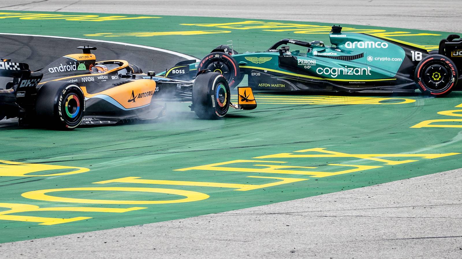 Daniel Ricciardo, McLaren, spins Lance Stroll, Aston Martin. Hungary, July 2022.