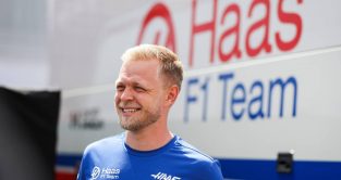 Kevin Magnussen smiling next to a Haas truck. Hungaroring July 2022.