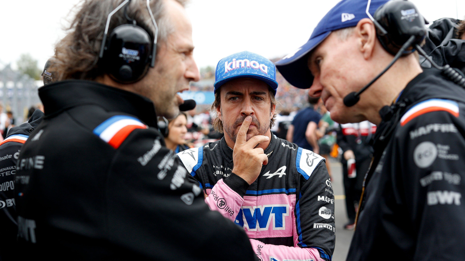 Fernando Alonso on the grid pondering with Alpine engineers. Hungary July 2022