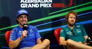 Fernando Alonso grinning next to Sebastian Vettel. Baku June 2022.
