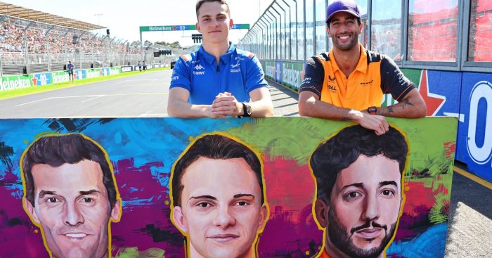 Oscar Piastri and Daniel Ricciardo standing with a mural. Melbourne April 2022.