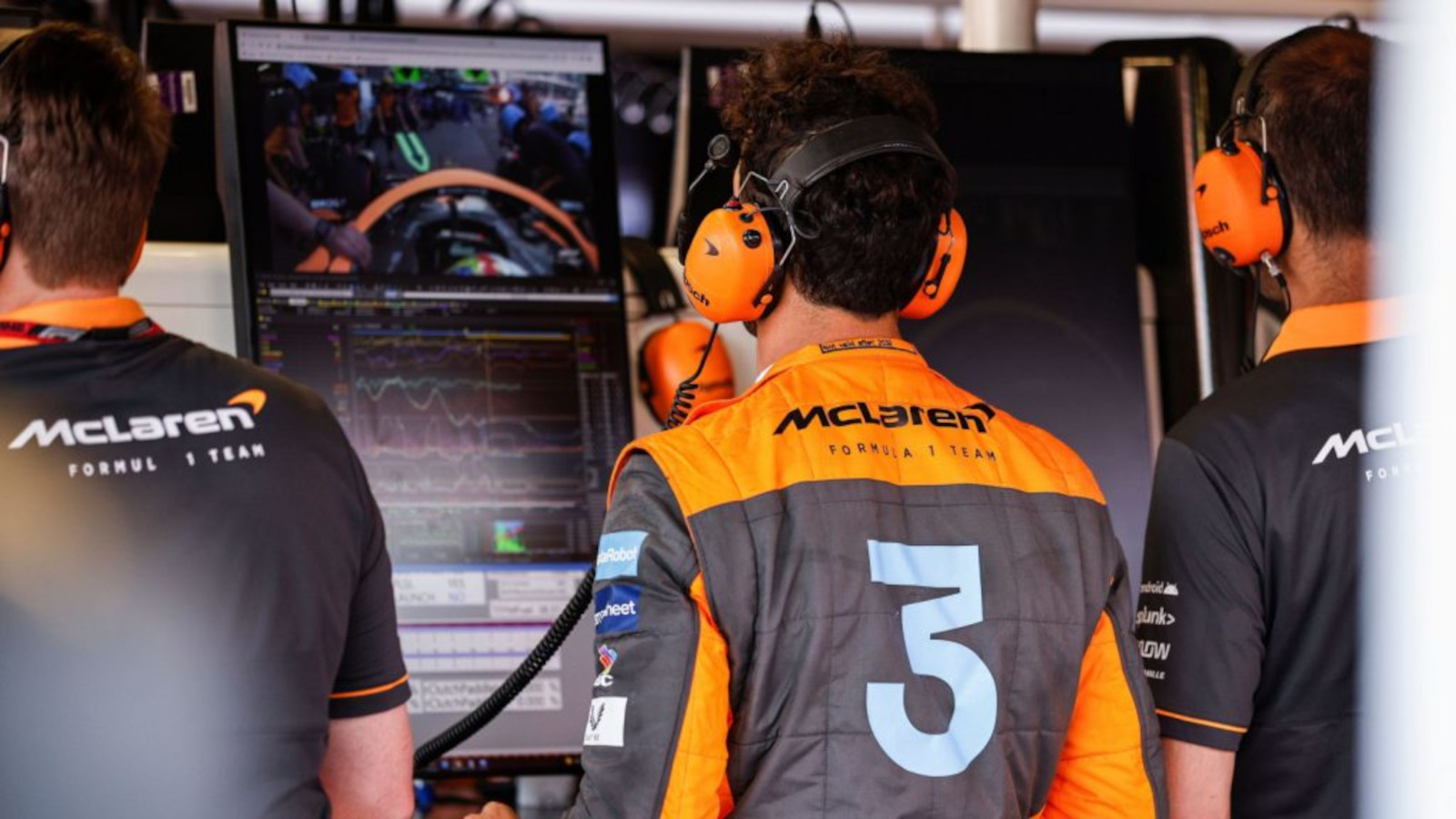 McLaren driver Daniel Ricciardo from behind looking at the screen in the McLaren garage. Monaco May 2022