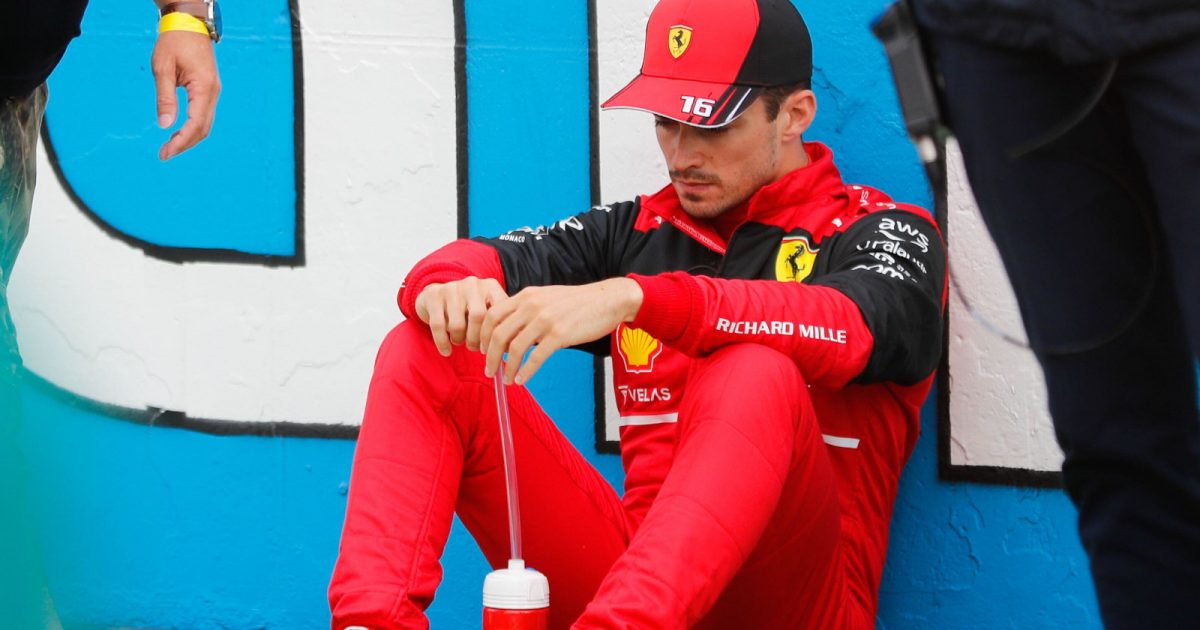 Charles Leclerc sitting against the wall on the starting grid. Hungary July 2022