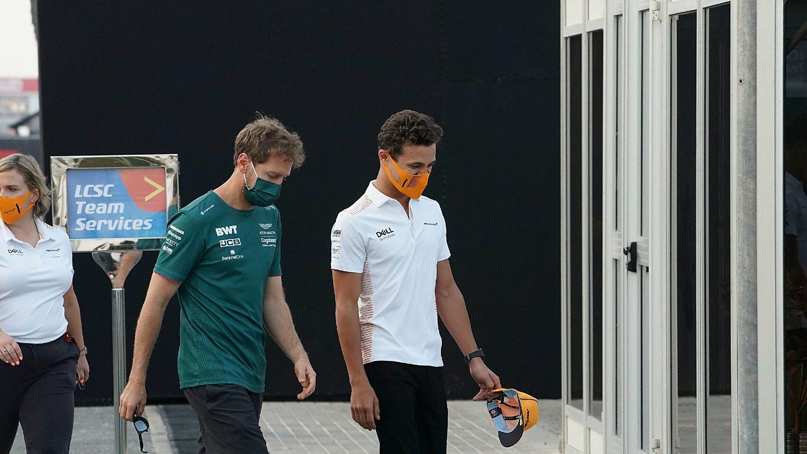 Sebastian Vettel, Aston Martin and Lando Norris, McLaren, walk together. Qatar, November 2021.