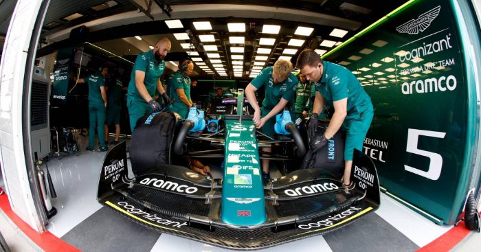 Aston Martin mechanics work on Sebastian Vettel's car. Hungaroring July 2022.