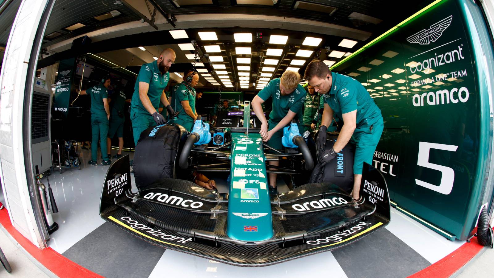 Aston Martin mechanics work on Sebastian Vettel's car. Hungaroring July 2022.