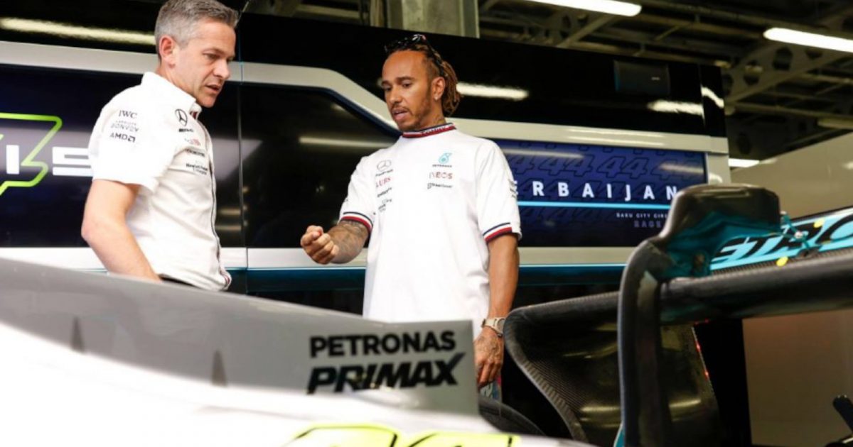 Lewis Hamilton standing in front of the car speaking with an engineer. Baku June 2022
