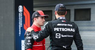 George Russell with his hand on Charles Leclerc's shoulder. Hungary July 2022