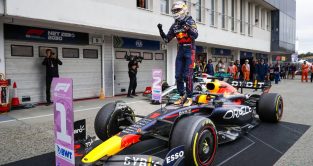 Max Verstappen stands on top of his Red Bull car. Hungaroring July 2022.