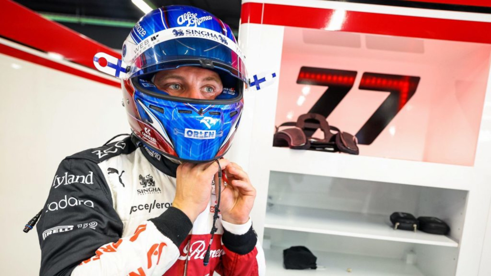 Valtteri Bottas tightening his helmet in the garage, 77. Spain May 2022