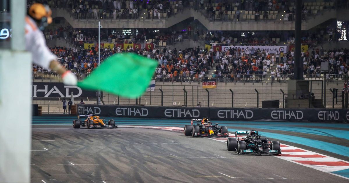 Lewis Hamilton leads Max Verstappen into the last lap of the Abu Dhabi GP. Yas Marina December 2021.
