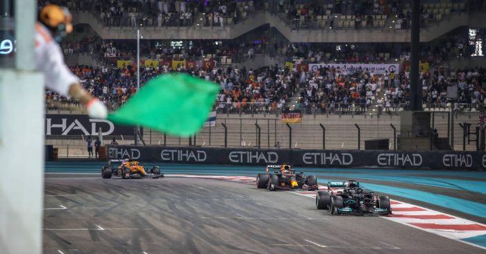 Lewis Hamilton leads Max Verstappen into the last lap of the Abu Dhabi GP. Yas Marina December 2021.