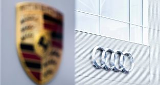 Audi logo in focus next to Porsche. Berlin February 2022.