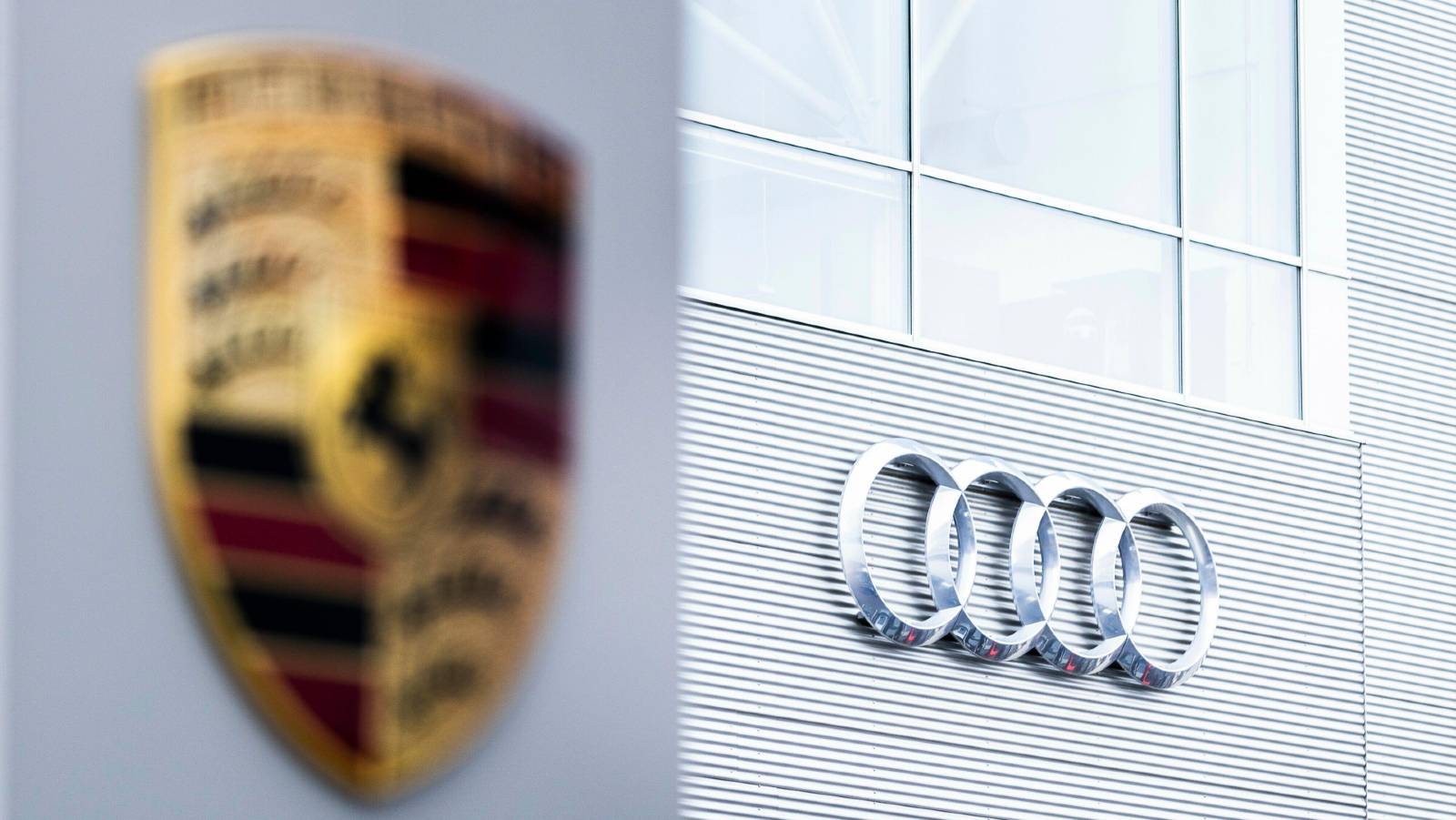 Audi logo in focus next to Porsche. Berlin February 2022.