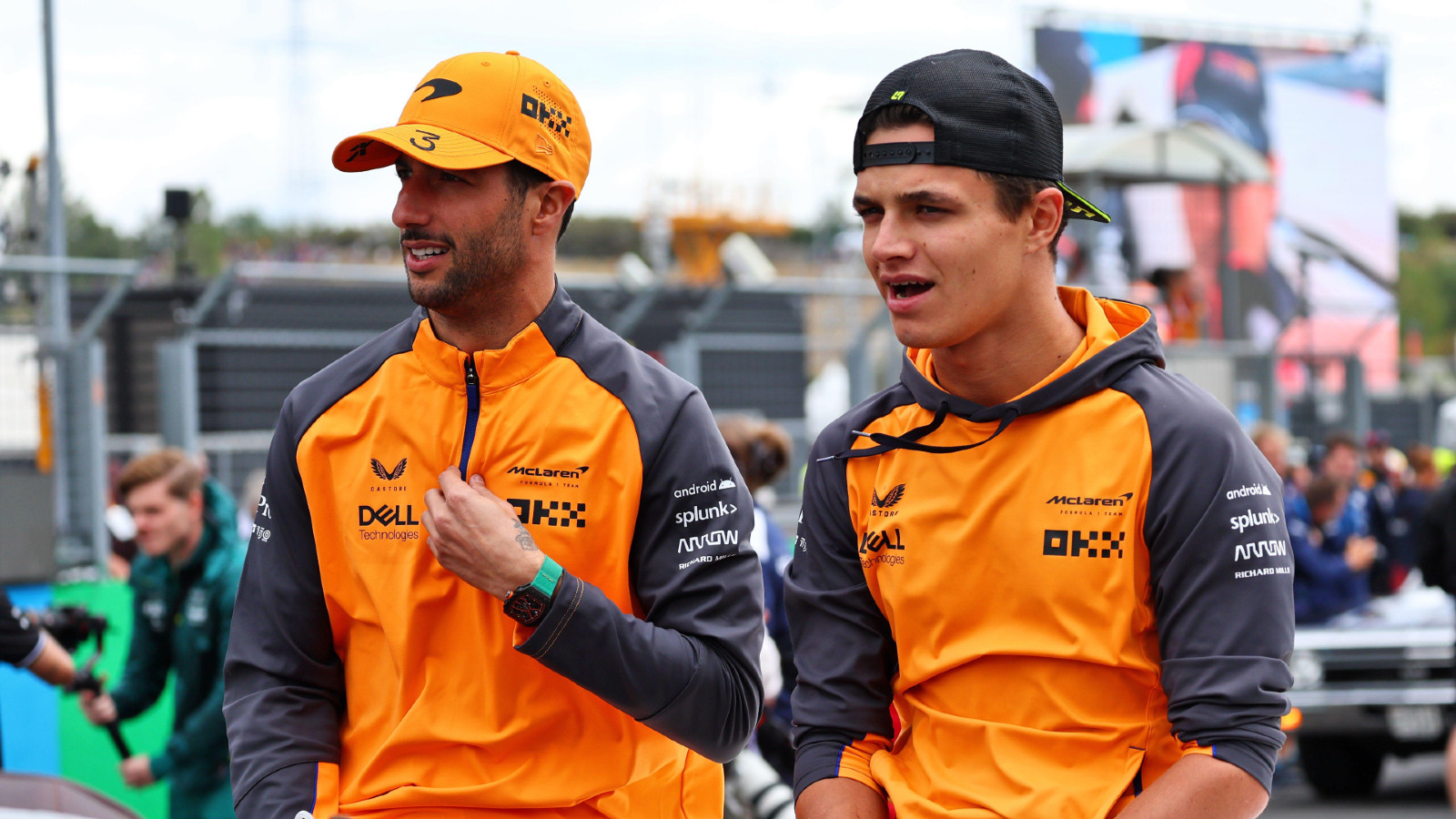 McLaren's Daniel Ricciardo and Lando Norris converse. Spa-Francorchamps, August 2022.