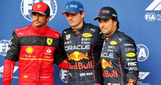 Red Bull's Max Verstappen celebrates pole position alongside Ferrari's Carlos Sainz and Red Bull's Sergio Perez. Spa-Francorchamps, August 2022.