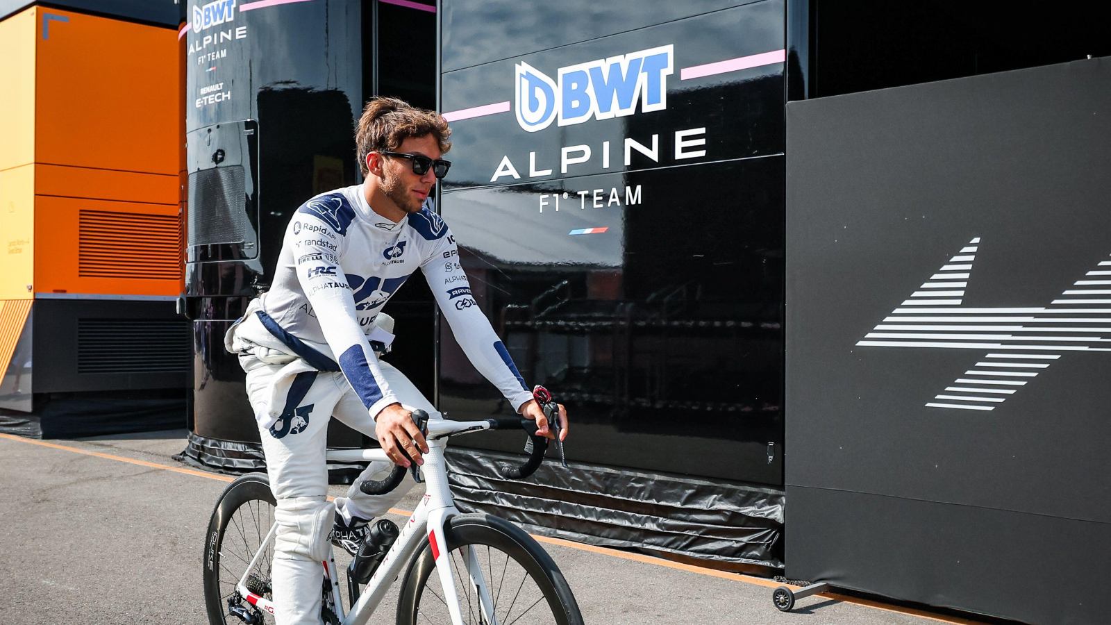 Pierre Gasly cycling by the Alpine motorhome. Zandvoort, September 2022.