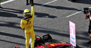 Charles Leclerc celebrates pole position in yellow race suit. Monza September 2022.