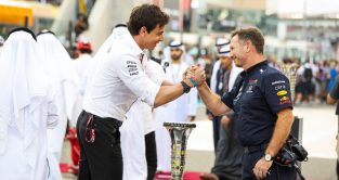 Mercedes' Toto Wolff and Red Bull's Christian Horner shake hands on the grid at the 2021 Abu Dhabi Grand Prix. Yas Marina, December 2021.