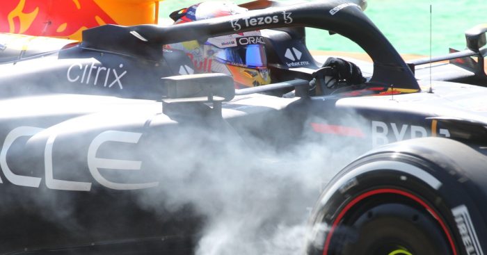 Sergio Perez drives with smoke coming from Red Bull right-front. Italy, September 2022.