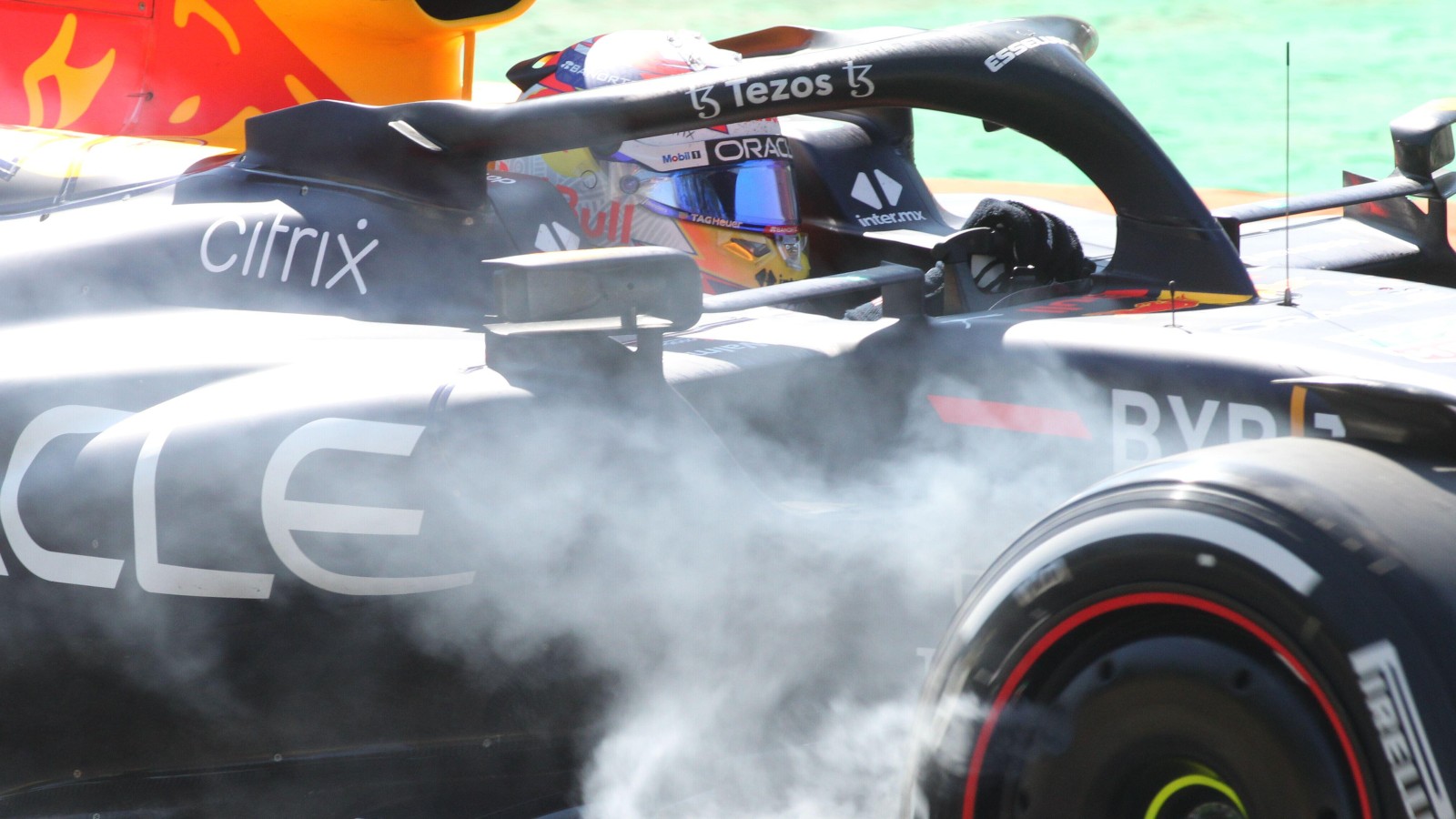 Sergio Perez drives with smoke coming from Red Bull right-front. Italy, September 2022.