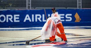 Marshals sweeping water off the track. Singapore GP. October 2022.