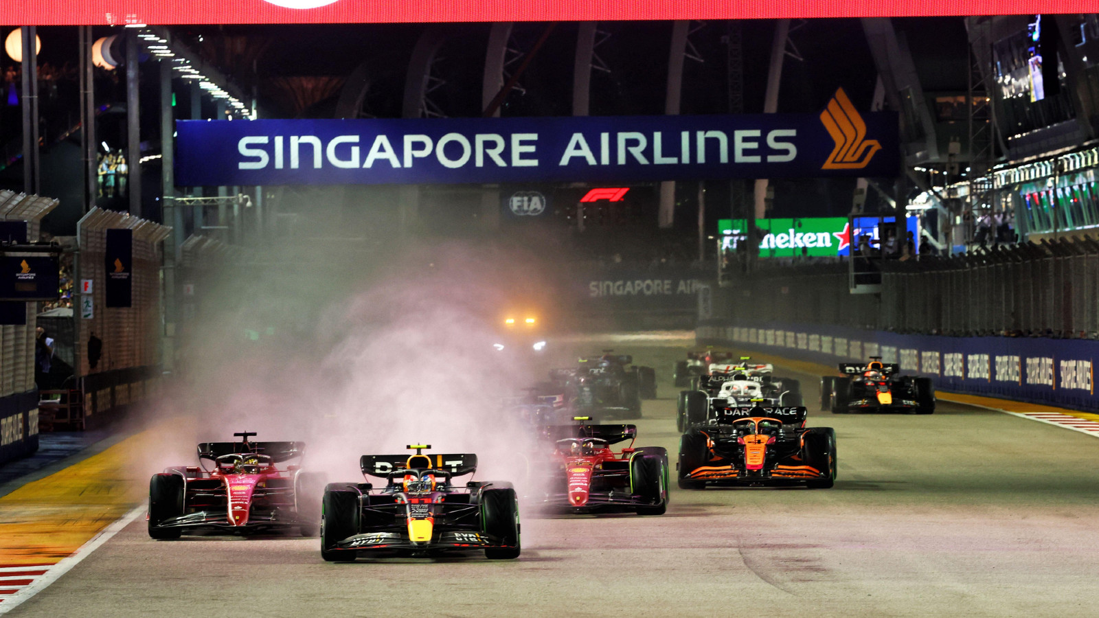 Red Bull's Sergio Perez leads Ferrari's Charles Leclerc into Turn 1 at the Singapore Grand Prix. Marina Bay, October 2022.