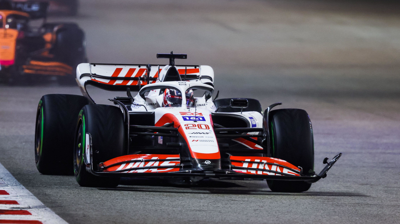 Kevin Magnussen ahead of Daniel Ricciardo, broken front wing. Singapore October 2022