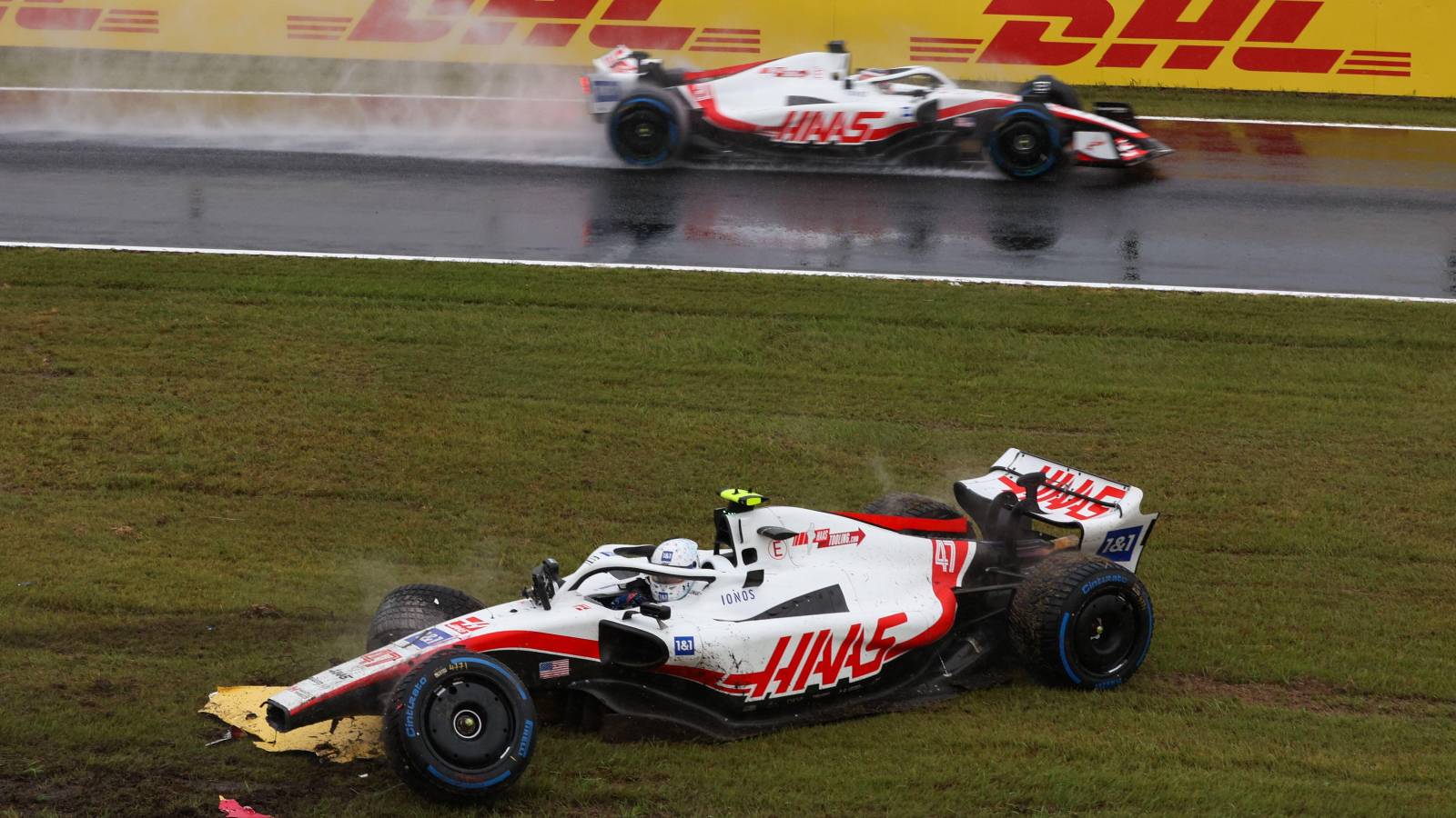 Kevin Magnussen, Haas, drives past stricken team-mate Mick Schumacher. Japan, October 2022.