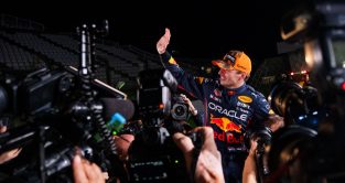 Max Verstappen waving as he is surrounded by photographers. Japan October 2022
