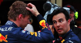 Max Verstappen, Red Bull, scratching head next to Sergio Perez. Suzuka October 2022.
